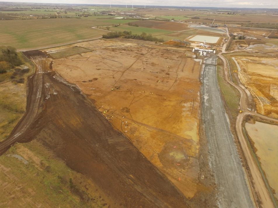 Aerial view of fields, one has been stripped and is being excavated