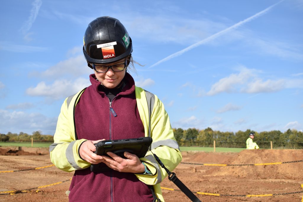 MOLA archaeologist using tablet to record on-site